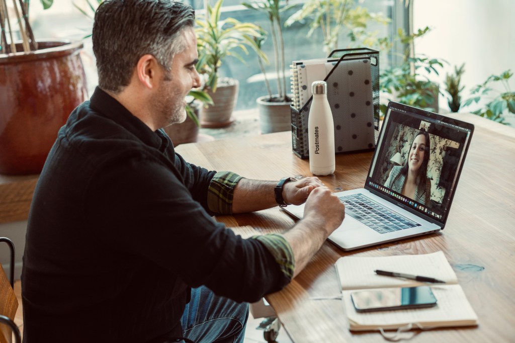 a man typing on a laptop