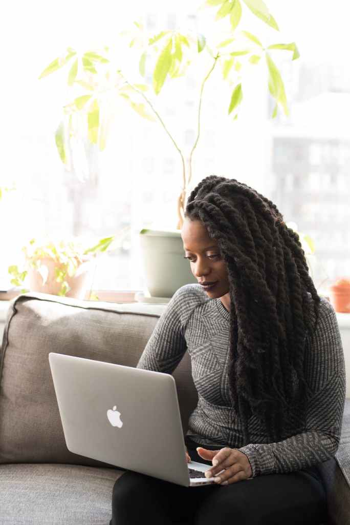 a woman typing on a laptop